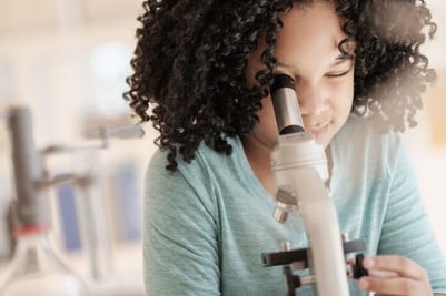 elementary-school-girl-observing-microscope