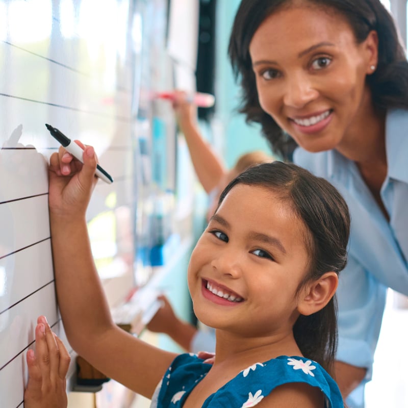 female teacher tutoring a girl