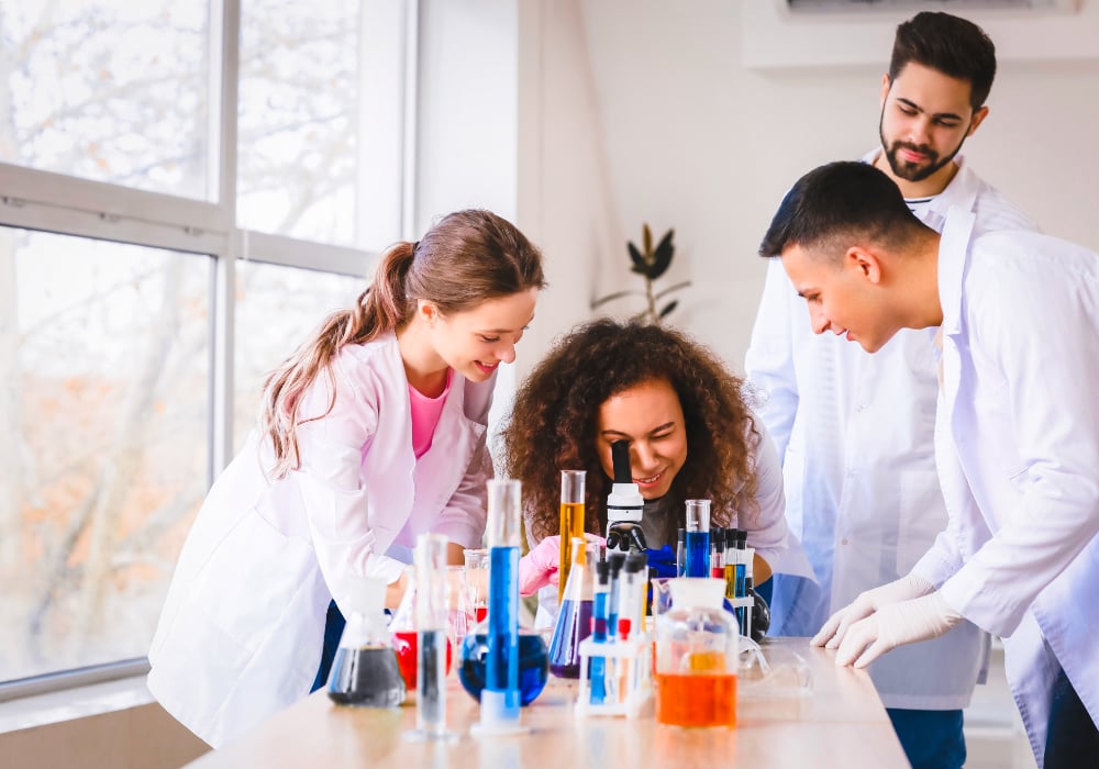 young university students doing a chemistry experiment