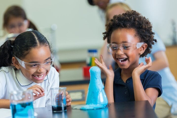 two-elementary-school-girls-chemistry-experiment